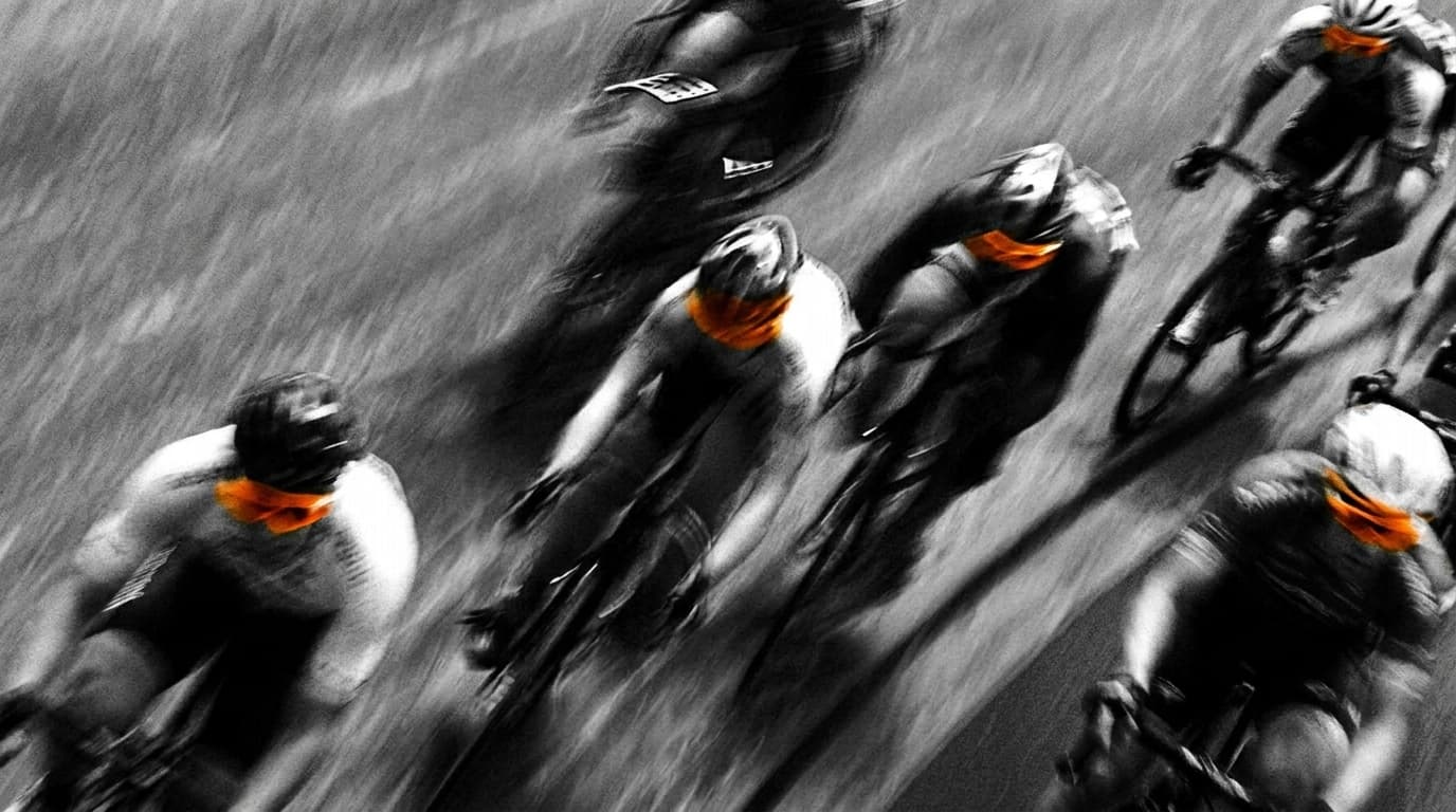 Peloton of riders at speed, motion blur